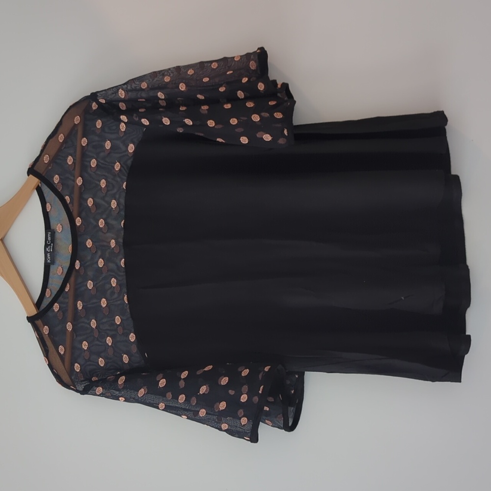 Flowing flirty top with sheer neckline and shoulders
